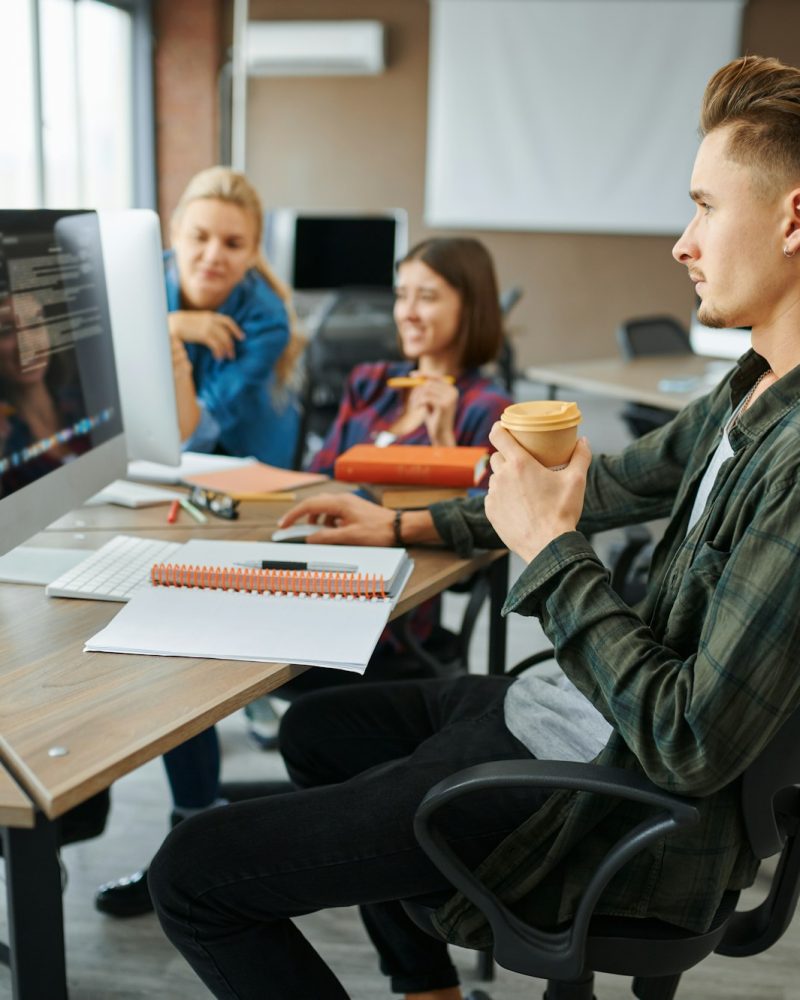 Young IT specialists works on computers in office